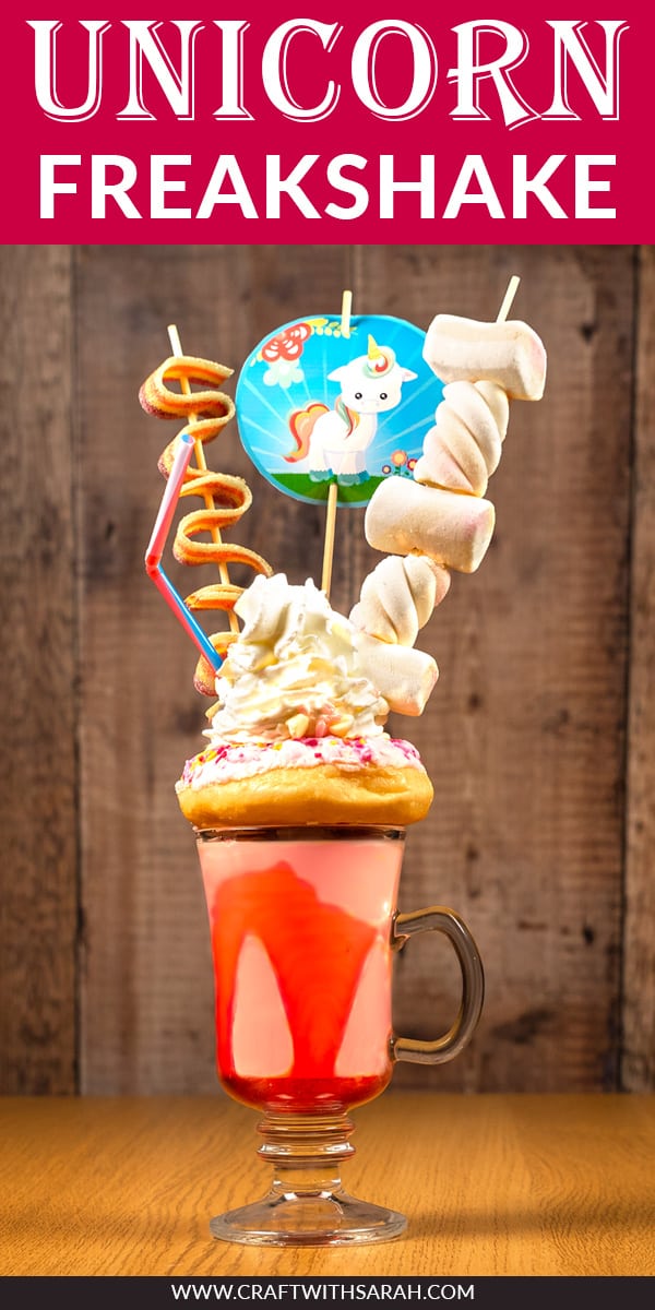 Slurrrrrrp! Who's up for a unicorn freakshake recipe? Enjoy this unicorn milkshake with tasty strawberry flavor, pink sprinkle donut, whipped cream, marshmallows, unicorn bacon and sprinkles. All finished off with a super cute printable unicorn cupcake topper. This unicorn milkshake recipe is perfect for unicorn lovers . The ultimate unicorn freakshake DIY! #freakshake #milkshake #unicorn #unicornrecipe