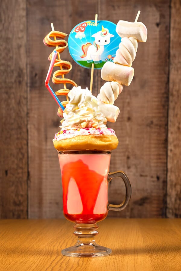 How to make a unicorn freakshake. Unicorn strawberry milkshake recipe with donut and sprinkles.