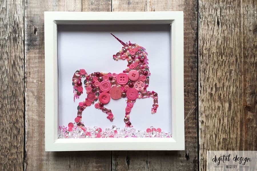 Completed unicorn button art framed in white box frame