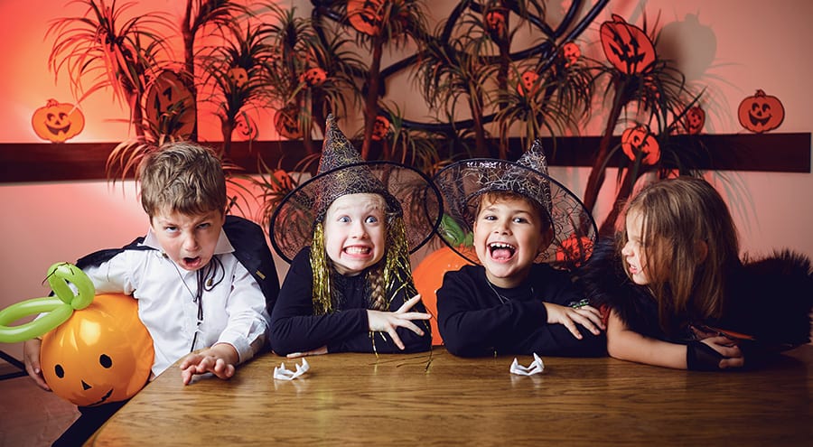 Kids in Halloween costumes having fun at a party