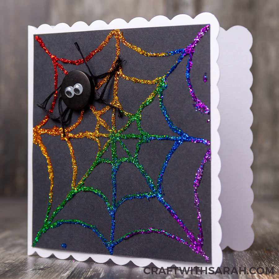 Handmade greetings card of a glittered spider web for Halloween