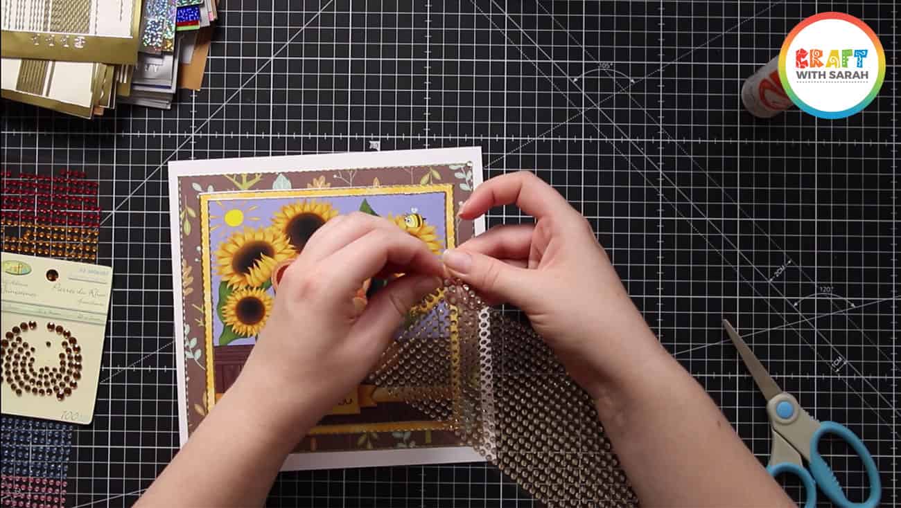 Attaching sticky gemstones to a card project