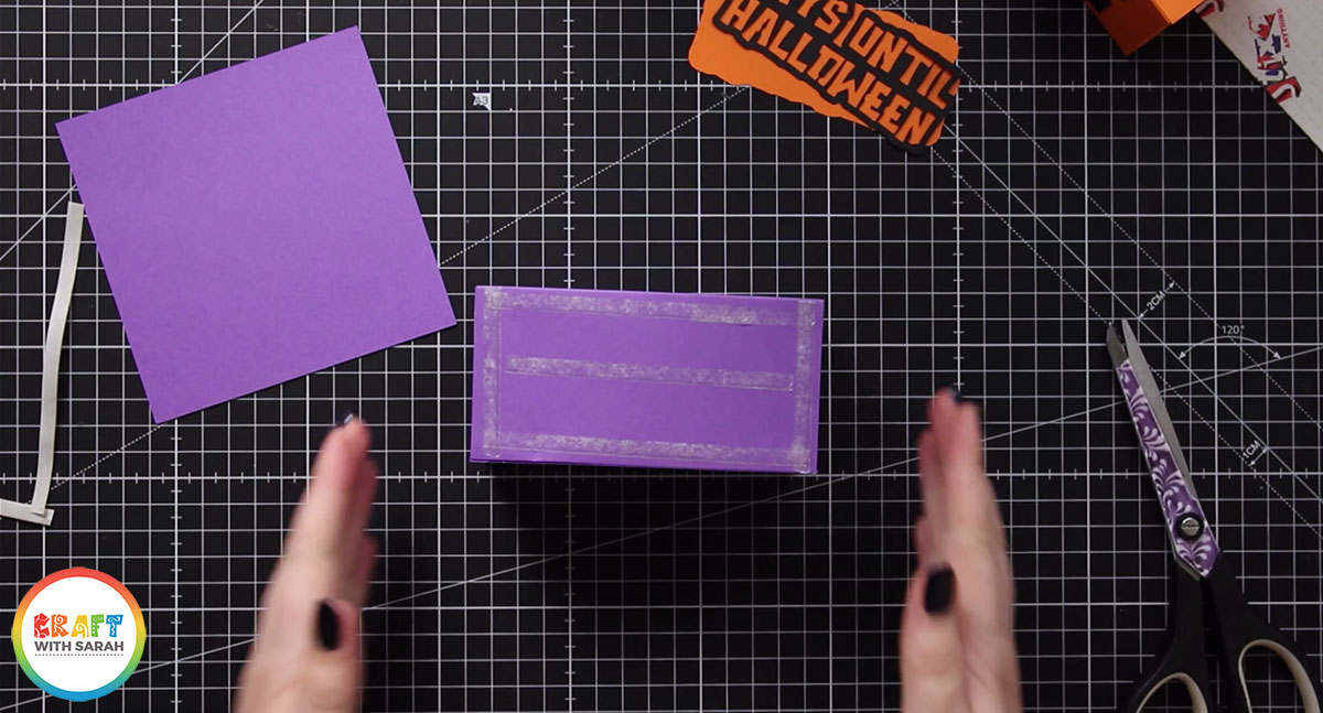 Add double sided tape to the back of the purple box