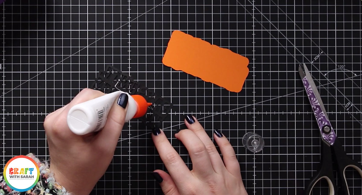 Glue the Happy Halloween sentiment to the orange shadow layer