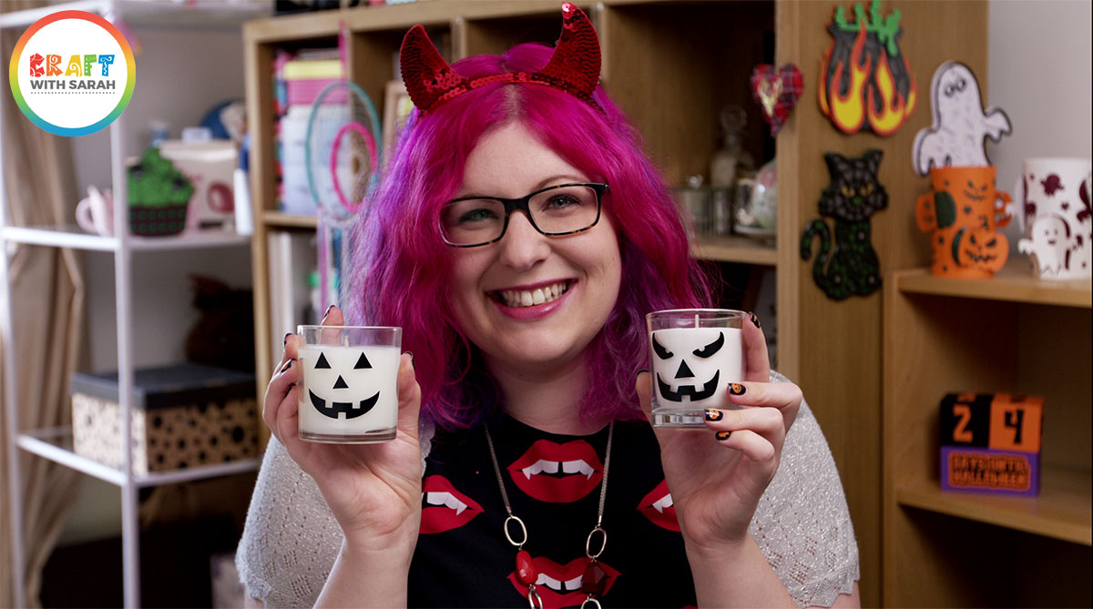 Sarah holding Halloween pumpkin face candles