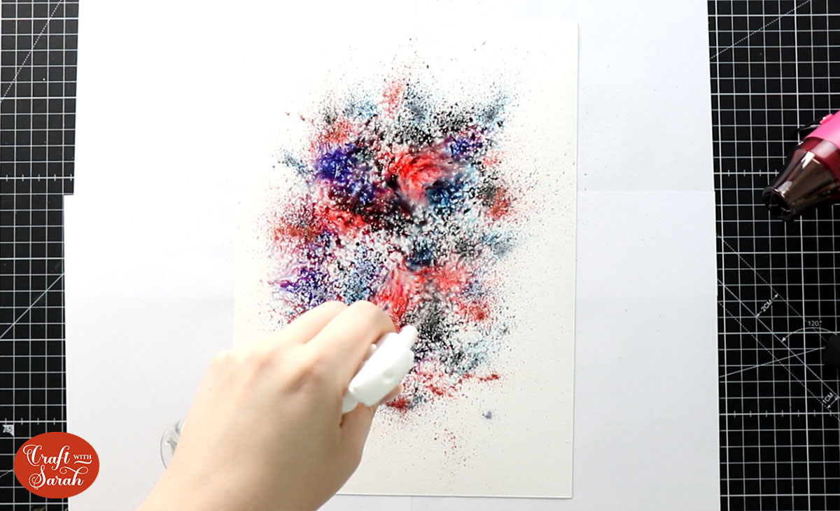 Spray water onto the paper