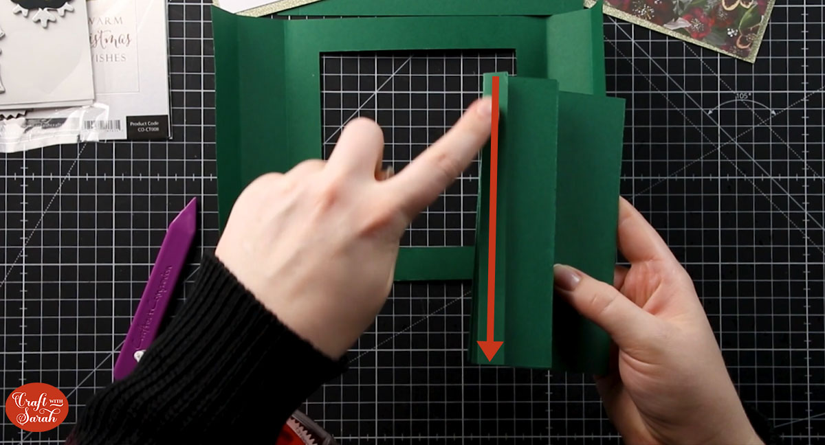 Add double sided tape along the tab shown by the arrow