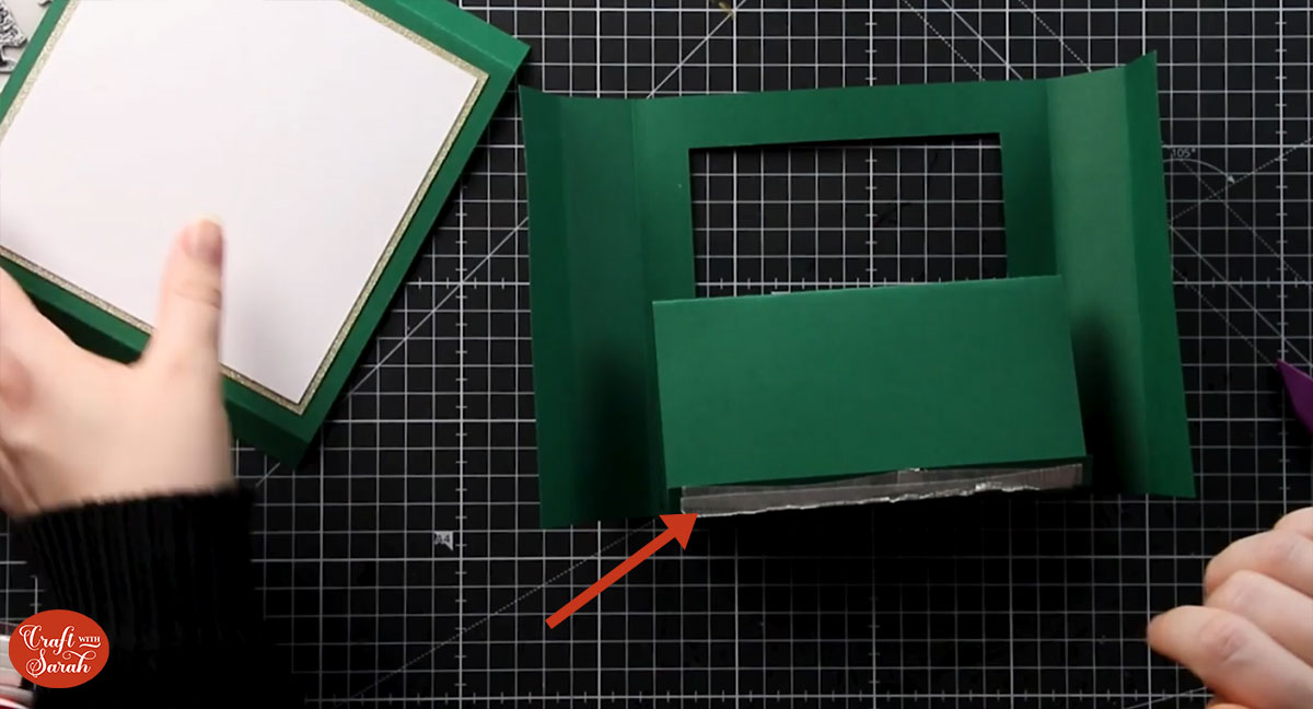 Add double-sided tape to the tab of card on the back of the concertina piece of card