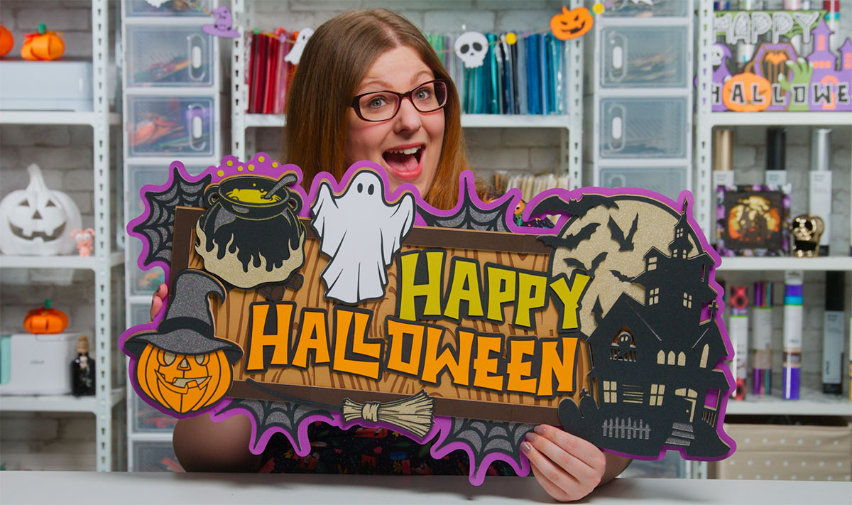 Sarah holding giant Happy Halloween sign